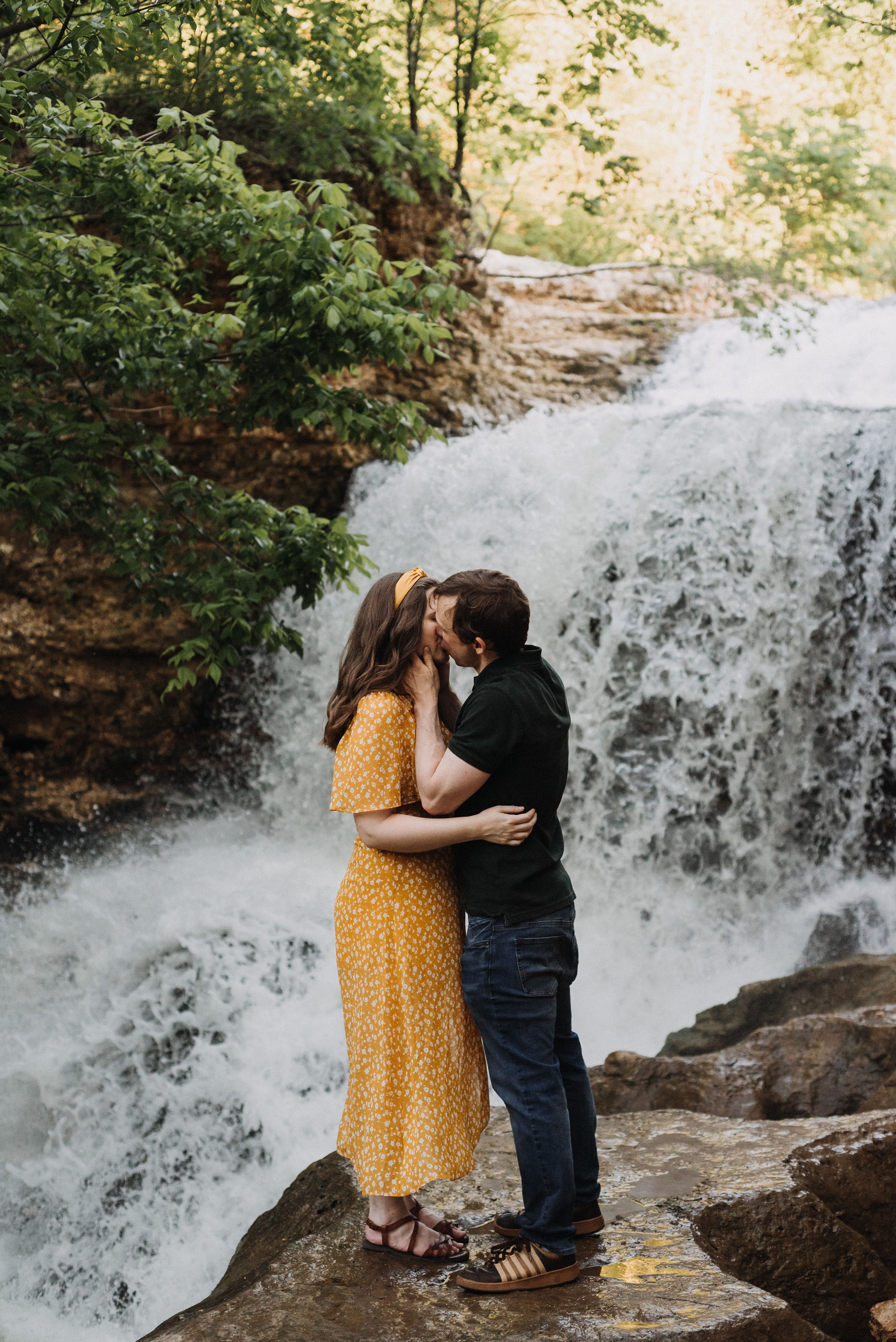 Couple kissing by a waterfall